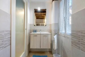 a small bathroom with a sink and a shower at Prima Del Cielo - Appartamento Lago in Esino Lario +34 photos