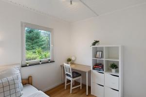 a bedroom with a desk and a bed and a window at Sauerland Oase in Meschede