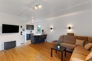 a living room with a couch and a television at Sauerland Oase in Meschede
