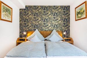 a bedroom with a bed with a wall mural at Krottenhill 2 ¼ in Ingenried