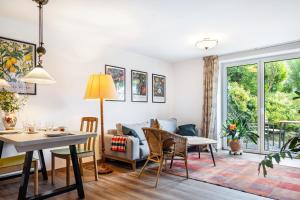 a living room with a table and chairs and a couch at Krottenhill 2 ¼ in Ingenried