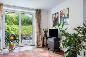 a living room with a sliding glass door at Krottenhill 2 ¼ in Ingenried