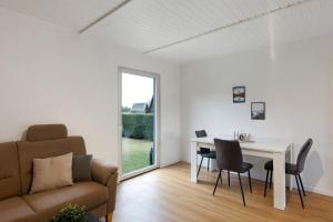 a living room with a table and a couch at Sauerland Oase in Meschede +15 photos