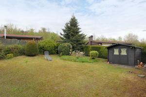 a backyard with a small black shed in the yard at Sauerland Oase in Meschede