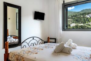 a bedroom with a bed with towels on it at Alkionides Apartment 3 in Agios Nikitas