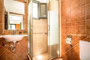 a bathroom with a sink and a shower at Alkionides Apartment 3 in Agios Nikitas