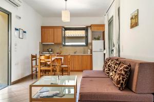 a living room with a couch and a table at Alkionides Apartment 3 in Agios Nikitas