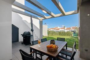 a wooden table with oranges on a patio at Casa do Sol and Golf - Vilamoura in Vilamoura