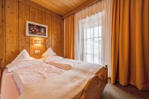 a bedroom with two beds in front of a window at Apartment Schwalbennest in Mühlbach