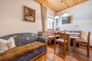 a living room with a couch and a table at Apartment Schwalbennest in Mühlbach