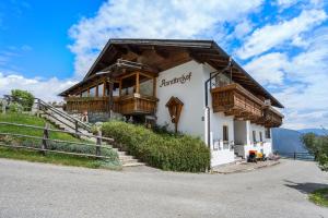 a building with a wooden roof on a hill at Apartment Schwalbennest in Mühlbach +9 photos
