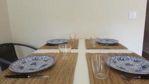 a table with blue and white plates and glasses on it at Estoril Sea You in Estoril +5 photos