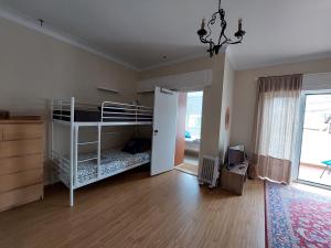 a bedroom with a bunk bed and a room with a window at Estoril Sea You in Estoril