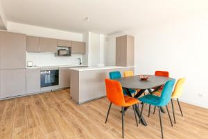 a kitchen and dining room with a table and chairs at Appartement Port Lin proche Océan in Le Croisic +12 photos