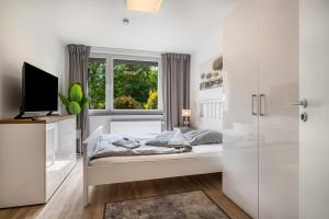a bedroom with a bed and a window at Kleines Glück in Delmenhorst