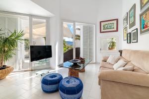 a living room with a couch and a tv at Casa Arola in Sant Josep de sa Talaia