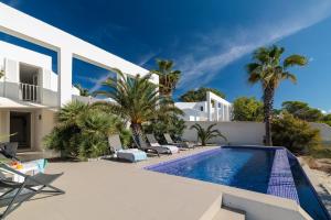 an external view of a villa with a swimming pool at Casa Arola in Sant Josep de sa Talaia