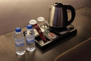 a tray with two bottles of water and a tea kettle at فندق روفان in Medina