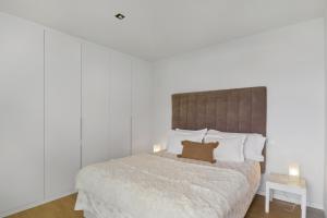 a bedroom with a bed with a brown pillow on it at Suitme-Agaete in Agaete +17 photos