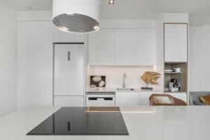 a white kitchen with a counter and a sink at Suitme-Agaete in Agaete