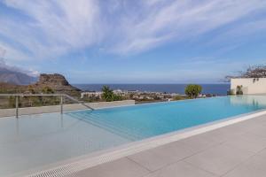 a swimming pool with a view of the ocean at Suitme-Agaete in Agaete
