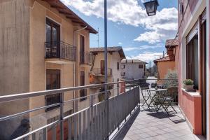 a balcony with a table and chairs on a building at Ragamà Massino Visconti in Massino Visconti