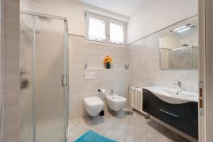 a bathroom with a toilet and a sink and a shower at Ragamà Massino Visconti in Massino Visconti +30 photos