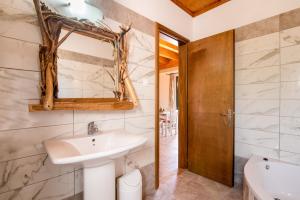 a bathroom with a sink and a mirror at Mirage Arillas Maisonette B in Arillas +22 photos