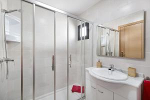 a white bathroom with a sink and a shower at Apartamento La Estrella I in Playa Honda +17 photos