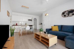 a living room with a blue couch and a table at Casa Alsa Beach in Icod de los Vinos