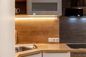 a kitchen with a sink and a microwave at Haus Alpenheim Apartment 2 in Tux +25 photos