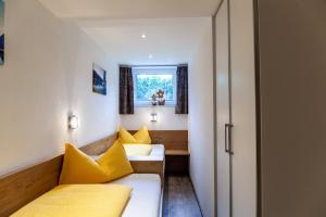 a small room with a bed and a window at Haus Alpenheim Apartment 2 in Tux
