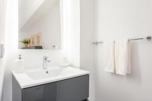 a white bathroom with a sink and a mirror at Casa La Bonita in Sóller +15 photos