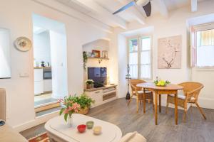 a living room with a table and a tv at Casa La Bonita in Sóller