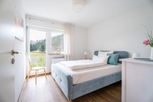 a bedroom with a bed and a window at Sonnenterrasse 9 in Fischerbach