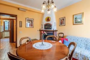 a dining room with a table and a couch at Casa Gaia in Prataccio +12 photos