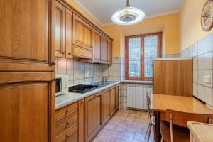 a kitchen with wooden cabinets and a wooden table at Casa Gaia in Prataccio