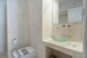 a bathroom with a bowl sink and a toilet at Helmos Cozy Studio in Naxos Chora