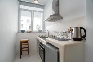 a kitchen with a stove and a counter top at Helmos Cozy Studio in Naxos Chora