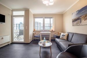 a living room with a couch and a table at Ferienwohnung Ausblick in Bremerhaven