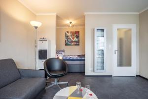 a living room with a couch and a table at Ferienwohnung Ausblick in Bremerhaven