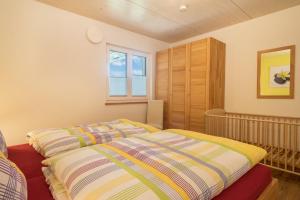 a bedroom with a bed and a crib at Ferienhof Weber Ferienwohnung Buche in Neukirch