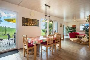 a dining room and living room with a table and chairs at Ferienhof Weber Ferienwohnung Buche in Neukirch