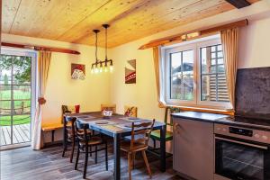 a kitchen with a dining room table with chairs at Chalet Rauschn 1 in Farchant