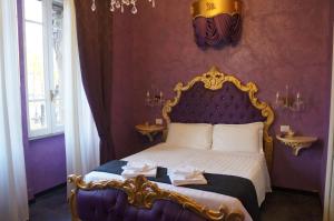 1 dormitorio con 1 cama extragrande y paredes moradas en Pope's Suites, en Roma