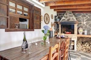 a kitchen with a wooden table and a fireplace at Finca Las Carmenes in Icod de los Vinos +28 photos