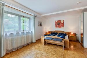 a bedroom with a bed and a large window at Ferienwohnung Sägegasse, Typ A in Münstertal