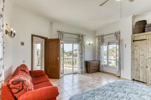 a living room with a red couch and a window at Flores in Vilacolum +25 photos