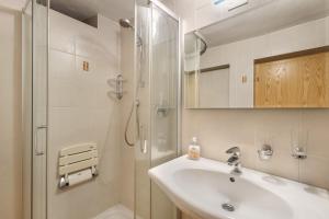 a white bathroom with a sink and a shower at Oberhof Bauernhaus in Vallarga +36 photos