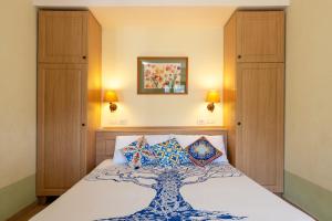a bedroom with a bed with a tree design on it at Cefalù Seaside Pool Villa in Cefalù +36 photos